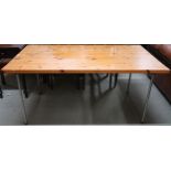 A contemporary pine topped work table on metallic supports, 71cm high x 153cm long x 83cm deep