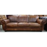 A contemporary Italian leather upholstered three seater sofa on turn feet, 85cm high x 233cm wide