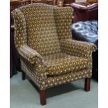 A large 20th century Georgian style open armchair with foliate upholstery on square supports,