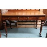 A Victorian mahogany two drawer hall table on turned supports terminating in brass casters, 80cm