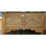 A 20th century oak Jacobean blanket chest with extensive carvings to top front and sides, 47cm