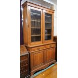 A late Victorian oak bookcase with moulded cornice over pair of glazed doors on base with two