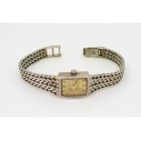 A 9ct white gold ladies Rotary quartz watch with decorative herringbone strap, weight with mechanism