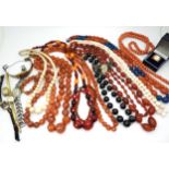 Good strings of black banded agate, carnelian, coral, shell, partial string of cherry amber coloured
