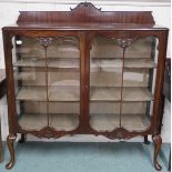 An early 20th century mahogany glazed display cabinet with pair of glazed doors on cabriole
