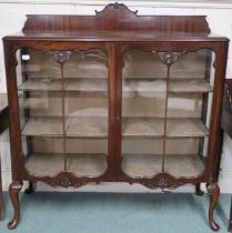 An early 20th century mahogany glazed display cabinet with pair of glazed doors on cabriole