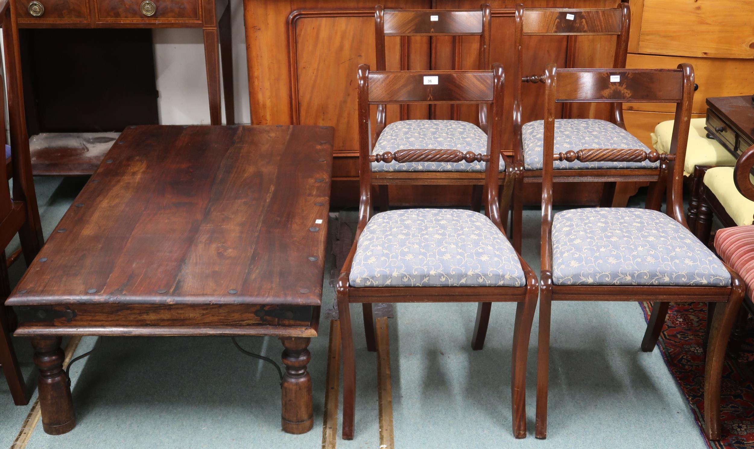 A lot comprising 20th century mango wood coffee table and four sabre legged dining chairs (5)