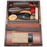A rosewood writing slope, with mixed contents including a London silver-mounted ebony-handled brush,