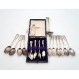 A collection of silver flatware including a cased set of twelve George V silver tea spoons and sugar