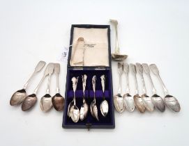 A collection of silver flatware including a cased set of twelve George V silver tea spoons and sugar