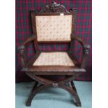 A Victorian oak Gothic revival hall armchair with upholstered splat carved with green man masque