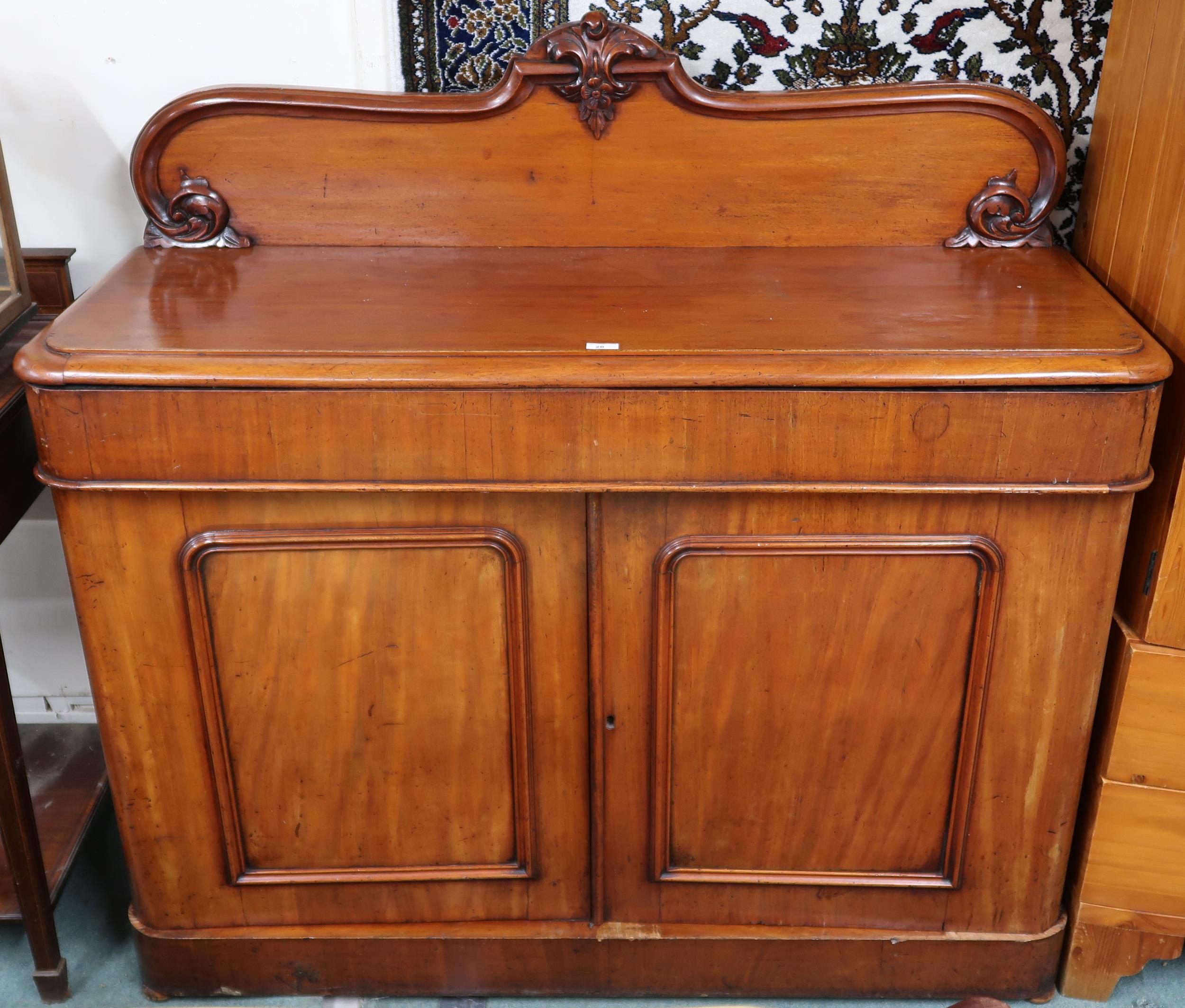 A Victorian mahogany sideboard with carved backsplash over single long drawer over pair of panel