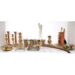 A mixed lot of assorted brass wares to include candlesticks, nut warmers, trivets, fire tools etc