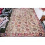 A cream ground James Templeton & Co Ltd carpet with all over floral patterned ground and red