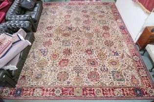 A cream ground James Templeton & Co Ltd carpet with all over floral patterned ground and red