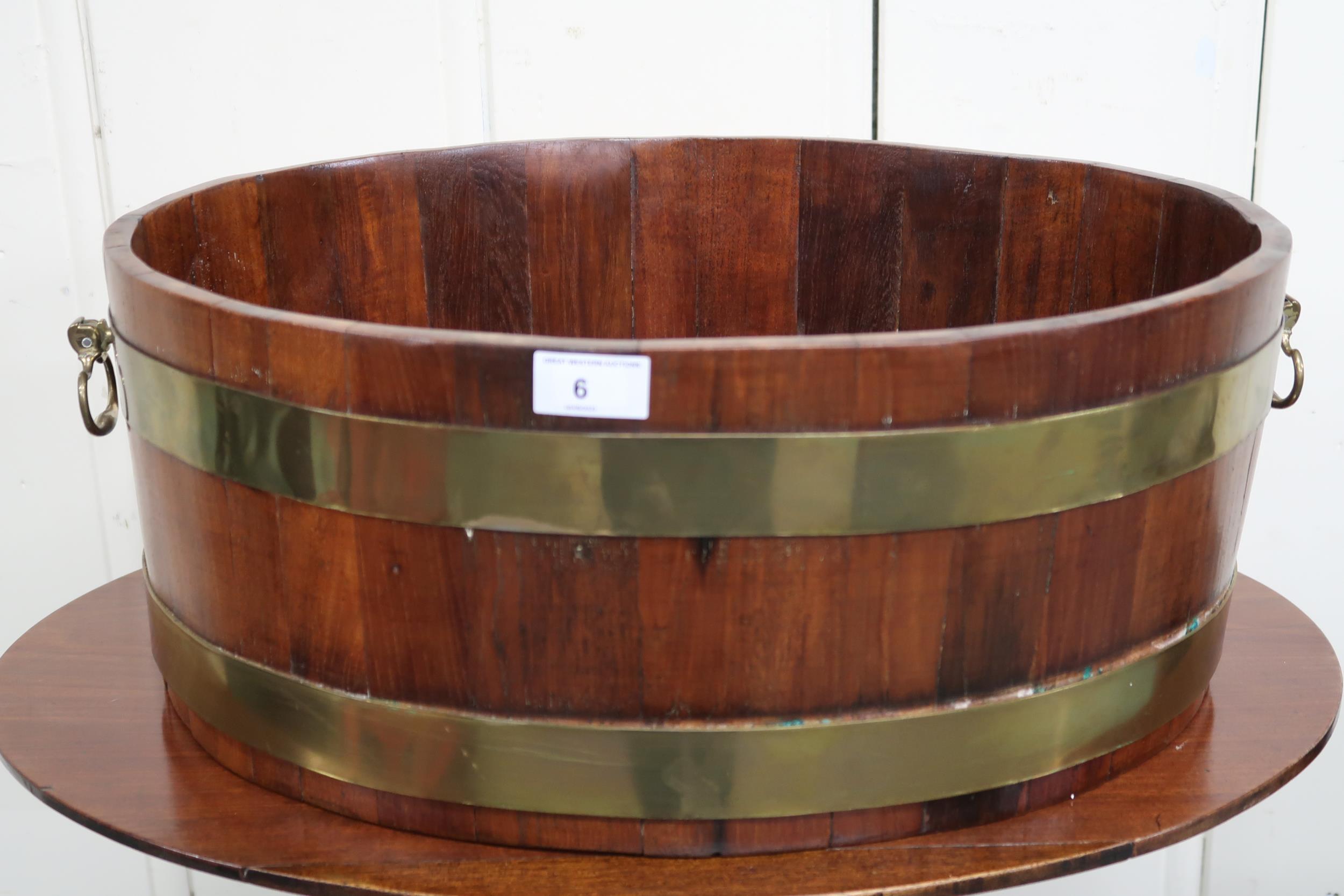 A 20th century oval teak and brass bound planter with twin brass handles, 21cm high x 55cm wide x - Image 2 of 2