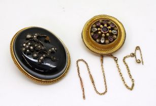 A Victorian mourning brooch, set with bullseye agate with a diamond set flower, in a bright yellow