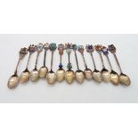 A collection of silver and guilloche enamel souvenir spoons, 200gms (13) Condition Report: