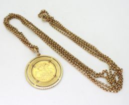 A 1931 gold full sovereign in a 9ct gold pendant mount with a 9ct gold guard chain, with 9c soldered