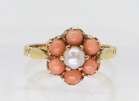 A 9ct gold coral and pearl flower ring, finger size J1/2, weight 2.6gms Condition Report:Available