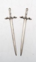 A pair of Elizabeth II silver letter openers, by Robert Allison, Glasgow 1958, modelled as swords,