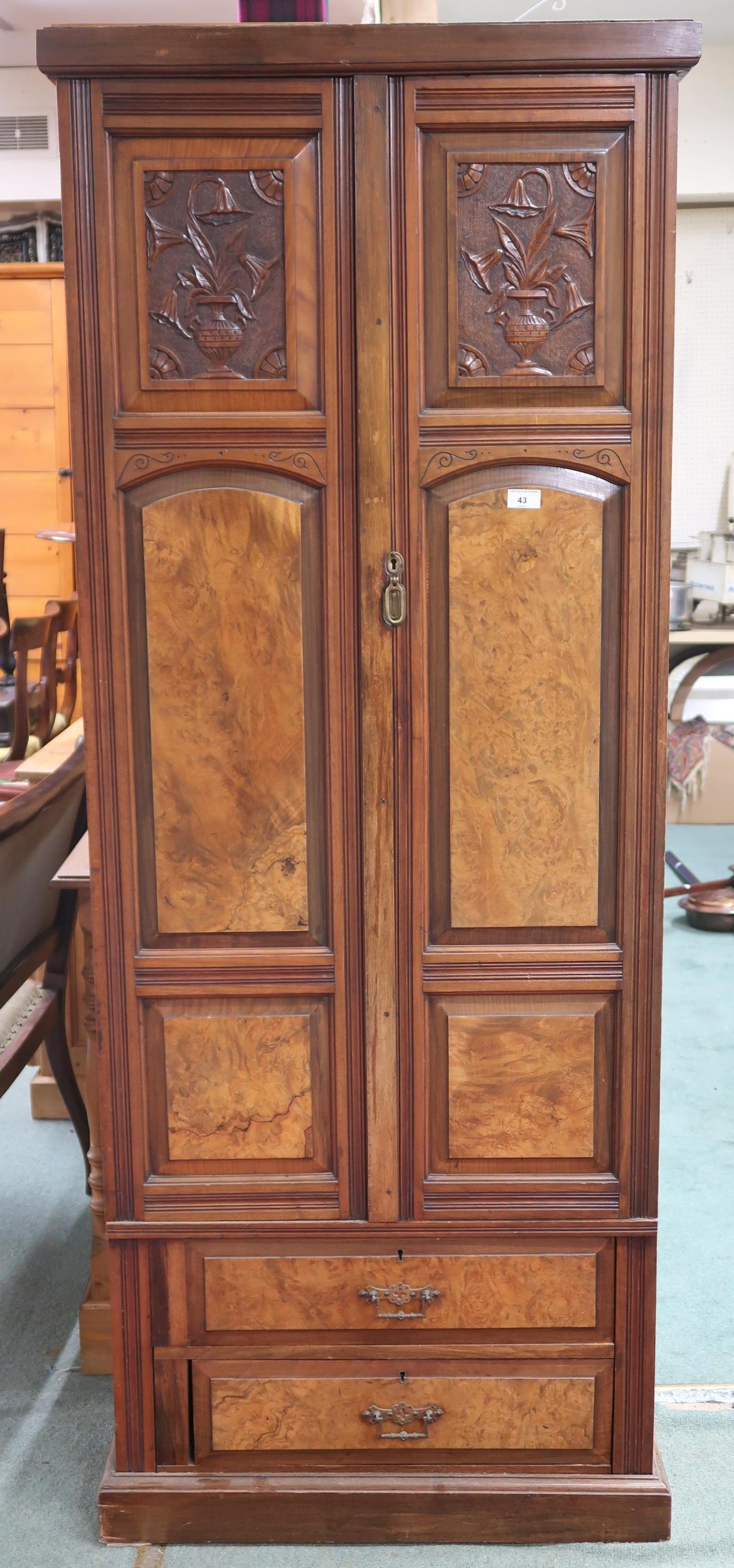 A Victorian mahogany and burr walnut veneered hall robe with two panel doors over two long drawers