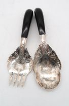 A pair of Persian silver salad servers, with ebonised handles and openwork bowls further engraved