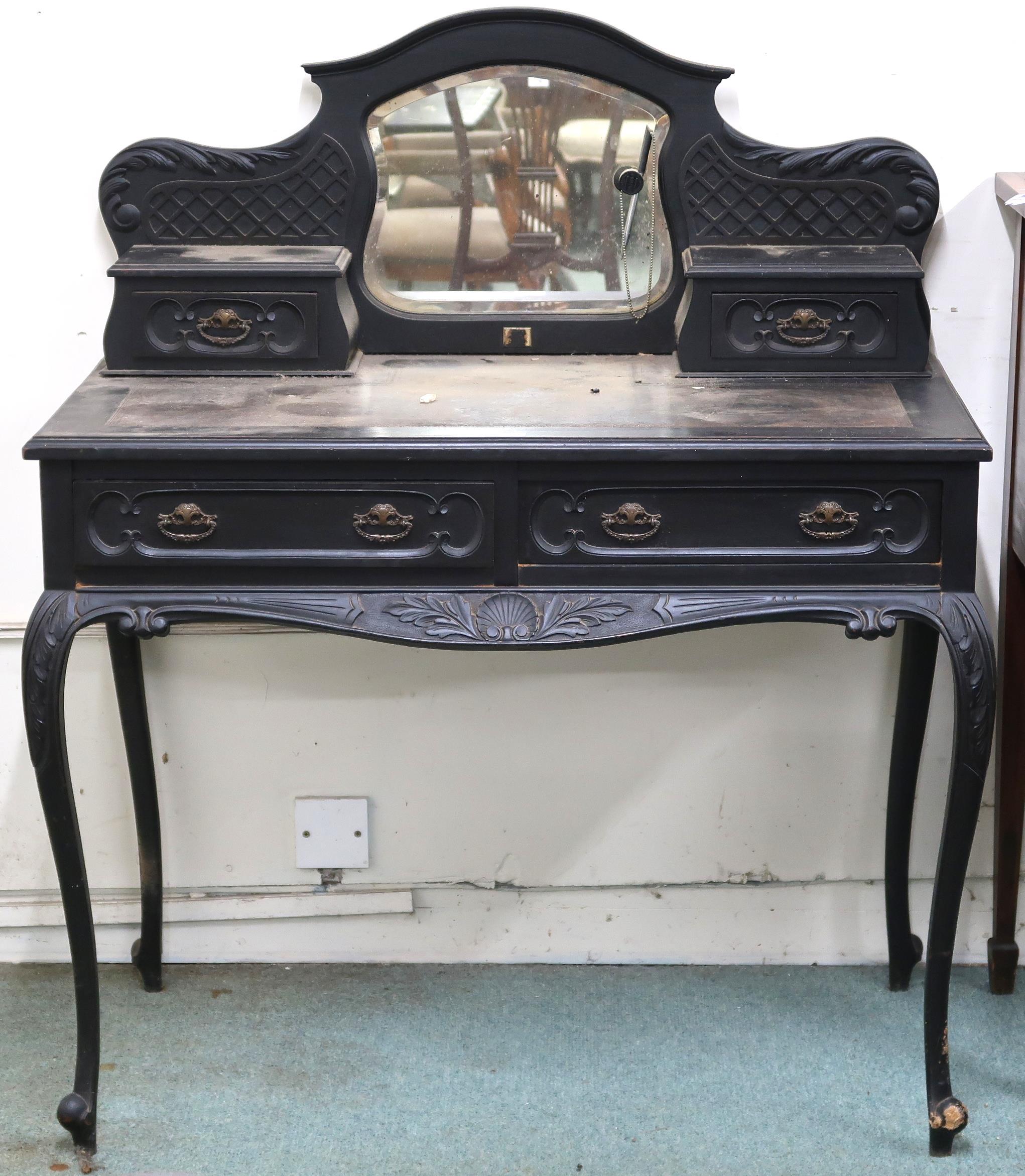 A 19th century continental style ebonised desk with shaped superstructure of central bevelled