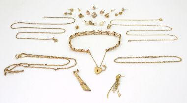 A collection of 9ct gold and yellow metal items to include a gate bracelet, chains and earrings,