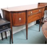 A 19th century mahogany sideboard with two central drawers flanked by bowed cabinet doors on