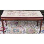 A Victorian floral tapestry upholstered piano stool on square tapering supports, 45cm high x 92cm