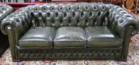 A 20th century forest green leather buttonback upholstered Chesterfield style three seater club