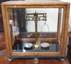 An early 20th century "Microid" glass cased scientific set of scales, 43cm high x 43cm wide x 28cm