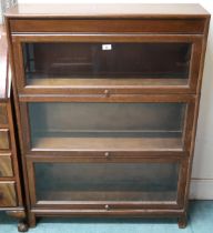 A 20th century oak Gunn three tier sectional bookcase with each section with glazed lift door, 117cm