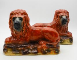 A pair of Bo'Ness style pottery lions with glass eyes Condition Report:Available upon request