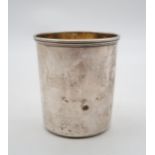 A Russian silver tumbler, assay master B.C / 1871, maker NP, Moscow, of plain form, with giltwash