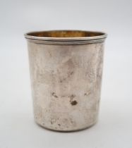 A Russian silver tumbler, assay master B.C / 1871, maker NP, Moscow, of plain form, with giltwash