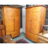 A pair of contemporary pine HP bow front armoires (one def) with pair of doors over two long drawers