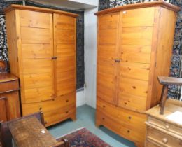 A pair of contemporary pine HP bow front armoires (one def) with pair of doors over two long drawers