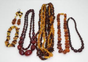 A collection of amber  coloured beads to include a facet cut cherry amber coloured necklace,