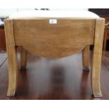 An early 20th century Art Deco style dressing stool with upholstered seat over shaped frieze sides