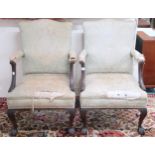 A pair of 20th century Georgian style open armchairs with green damask upholstery on cabriole ball