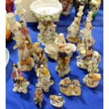A collection of Chelsea style figures, a pair of candlesticks, a figural tazza and other figures