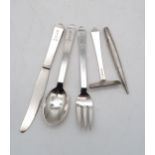 Georg Jensen; a silver Christening set, in the pyramid pattern, monogrammed RYH 1931, with London