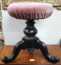 A Victorian adjustable piano stool with pink velour seat cover on ebonised tripod base, 47cm high