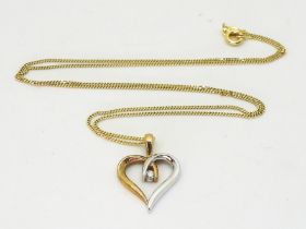 A 9ct yellow and white gold heart shaped pendant and chain set with estimated approx 0.03ct