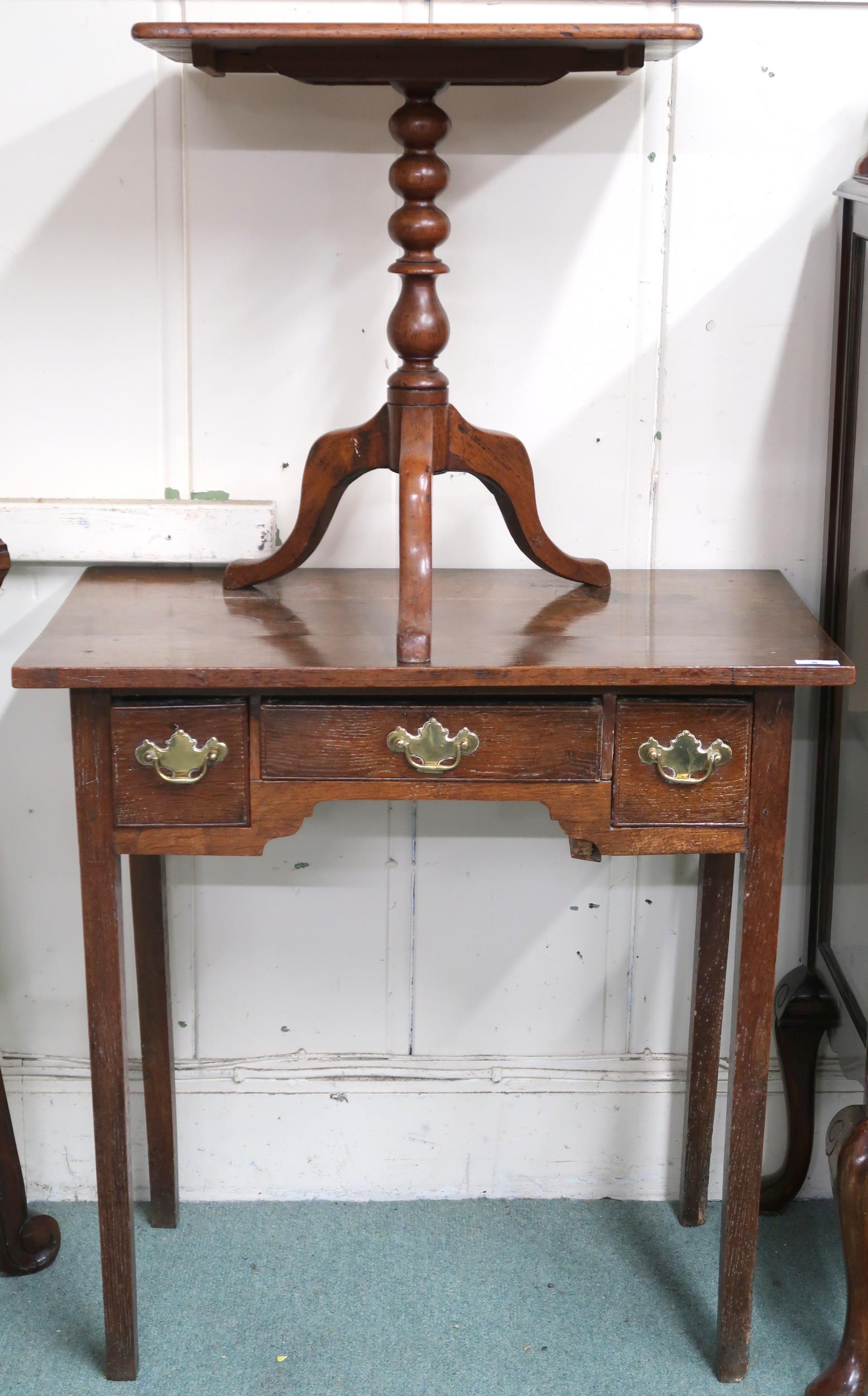 A 19th century oak low boy style table with central drawer flanked by single drawer over shaped