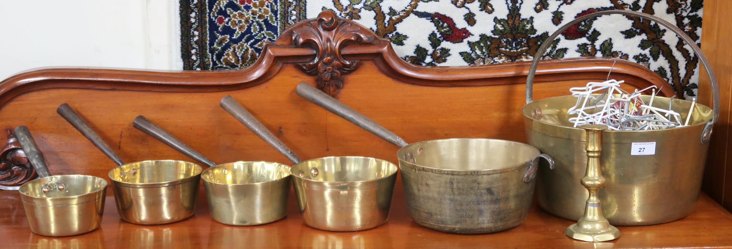 A lot of brass ware to include jelly pan, five assorted saucepans and a candlestick (7) Condition