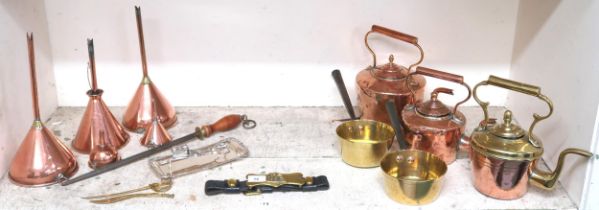 A mixed lot of copper and brass wares to include copper funnels, kettles, plate candle snips etc