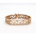 A 9CT GOLD WAVE PATTERN BRACELET interspaced with sparkling cubic zirconia, length of the bracelet